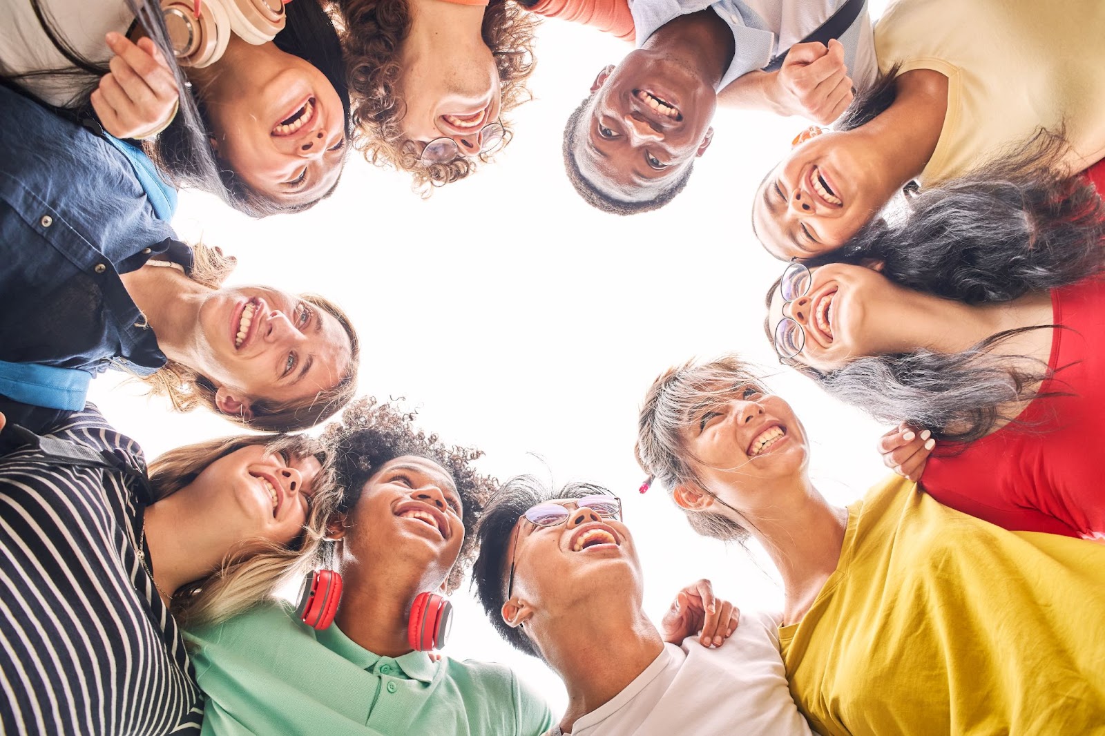 Group of people huddled in a circle. 