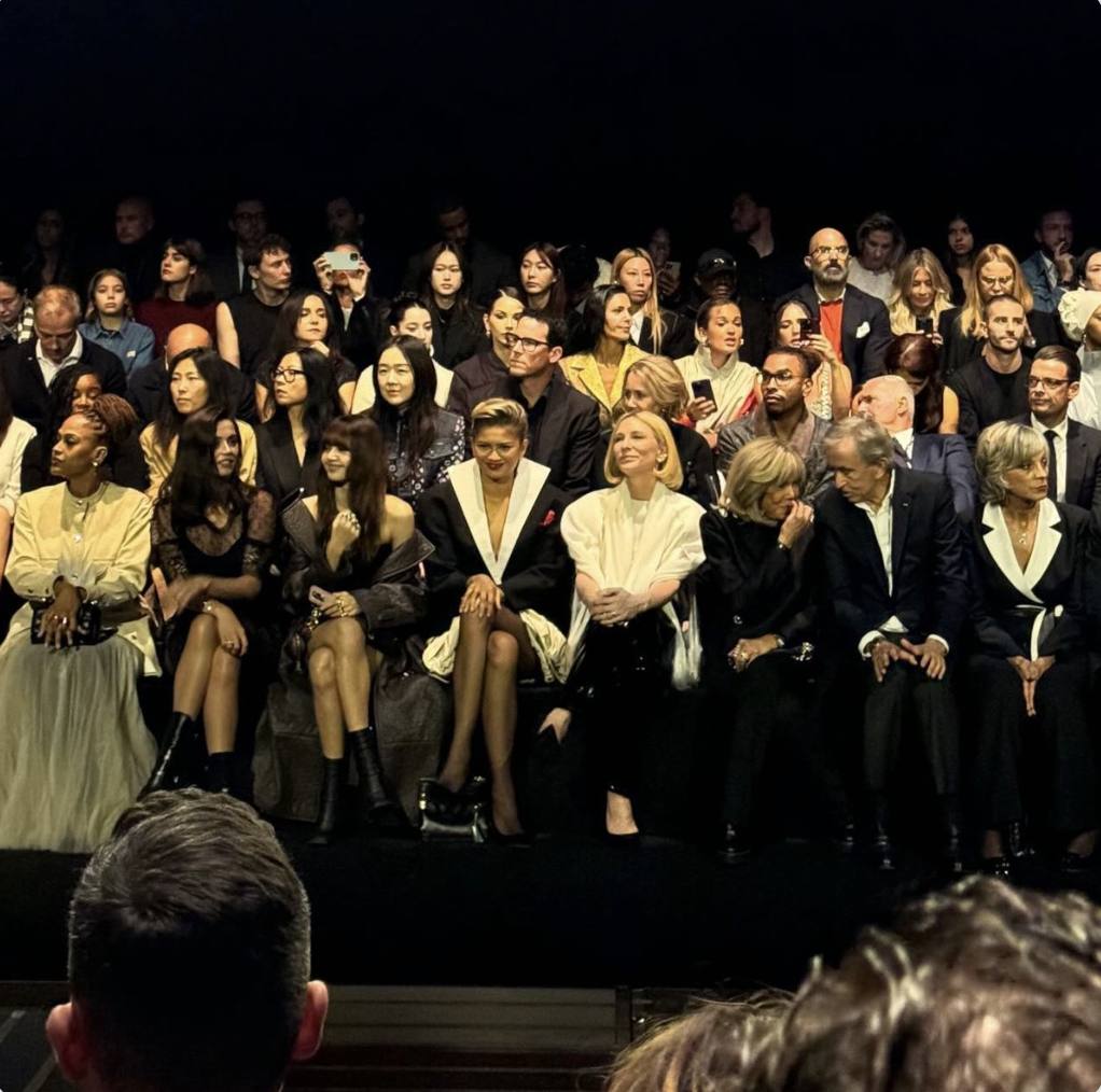 This image contains picture of Lisa, along with Zendaya, was given prime real estate in the front row, rubbing elbows with the likes of France's First Lady and LVMH's CEO 