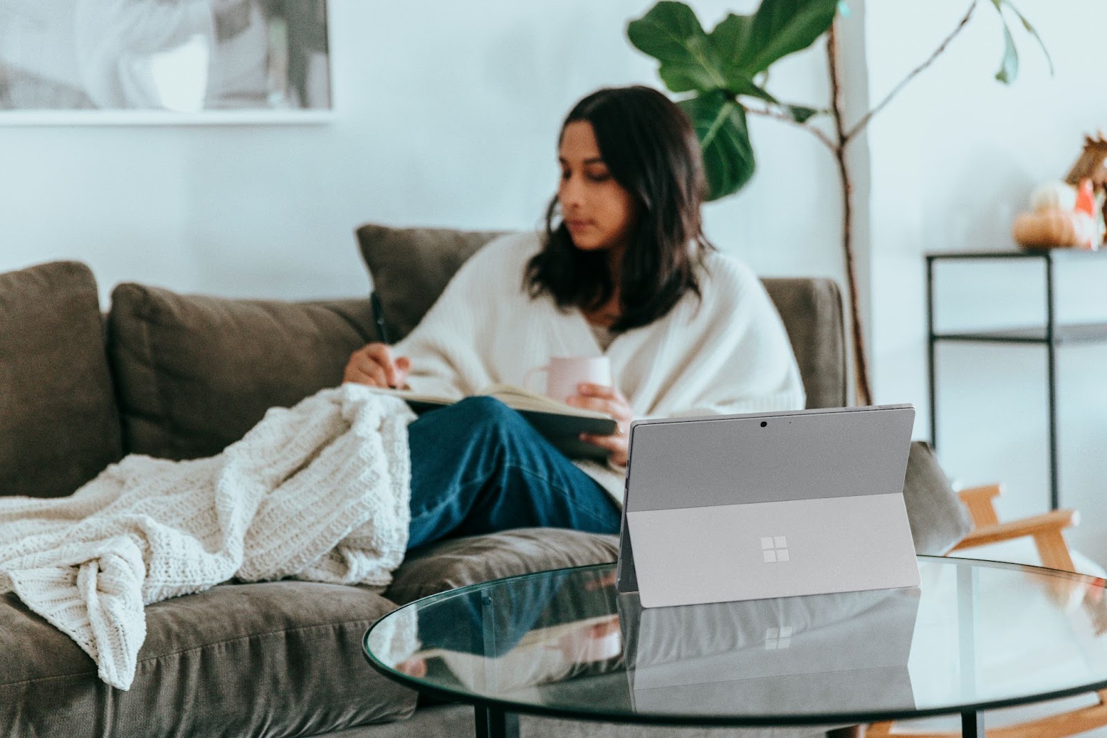 Woman working remotely from her sofa