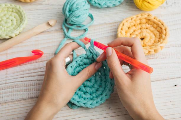 woman hands knitting crochet. hobby crafts things. Top view. Horizontal composition Hand made hobby crafts things. woman hands knitting crochet.  Top view. Horizontal composition crochet stock pictures, royalty-free photos & images