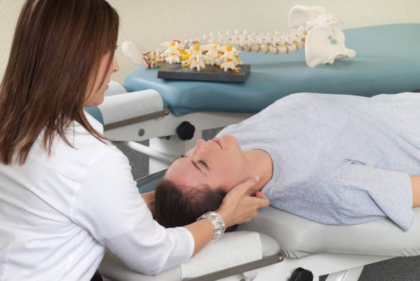 A chiropractor gently adjusting a woman's upper neck, demonstrating a precise treatment for atlas misalignment.