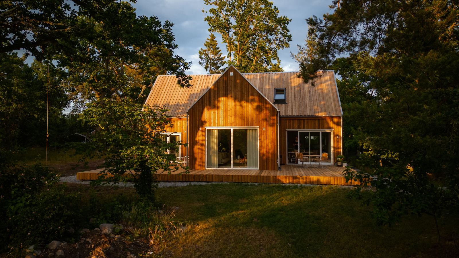 A house with engineered wood siding is pictured during the morning. The sun is rising and shining on the siding.