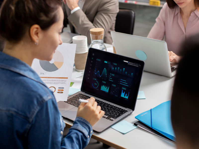 Professional reviewing claims performance dashboards on a laptop, with data insights enabled by FNOL automation