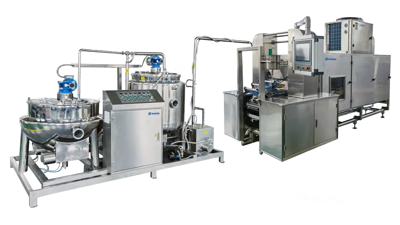 Two large industrial machines used for processing and packaging products. The left machine features a control panel and mixing vessel, while the right machine is equipped with multiple components for automated packaging. Branded as GummyGenix by SaintyCo, these gummy making machines are metallic with various attached pipes and wires.