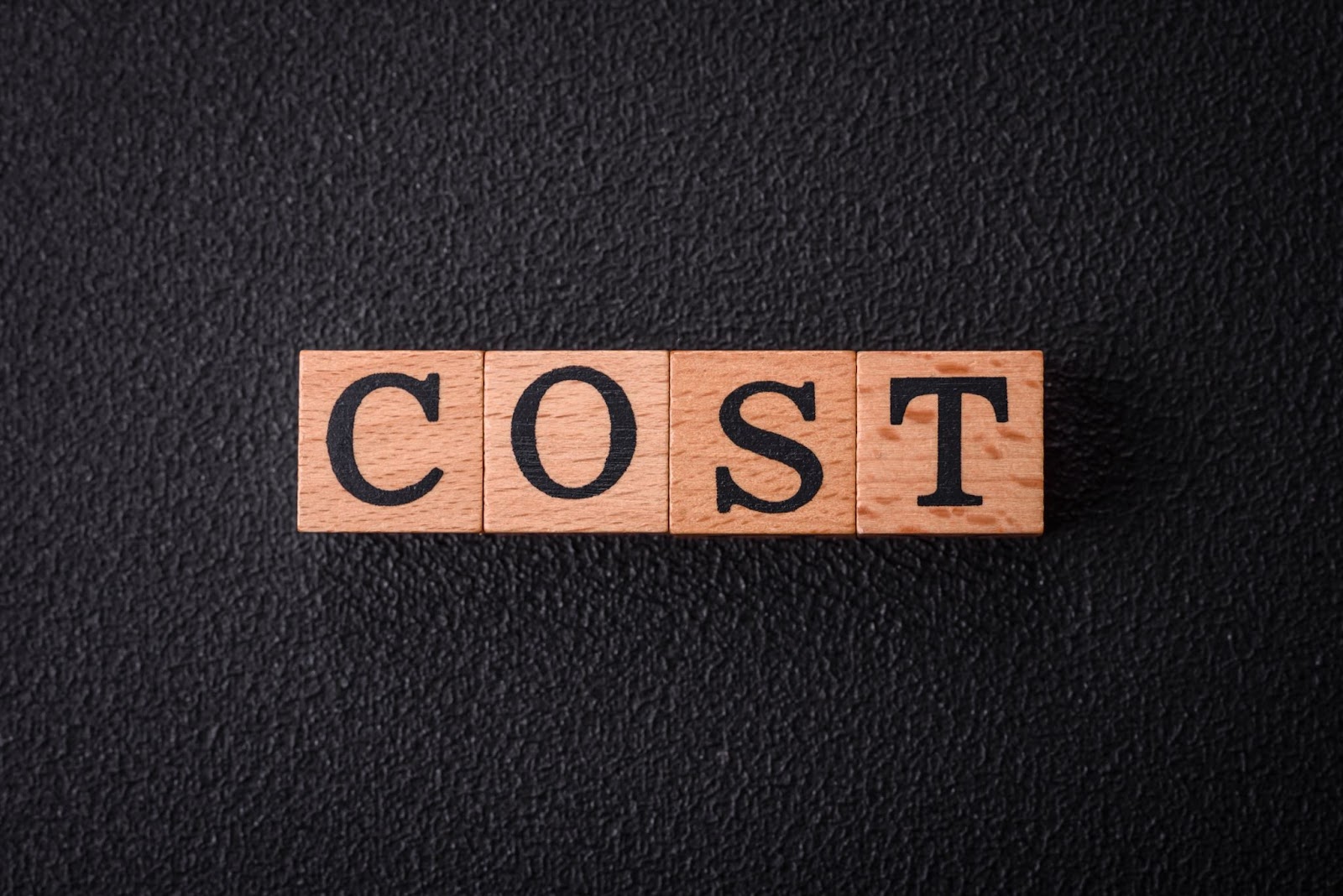 Word “cost” on wooden blocks. 