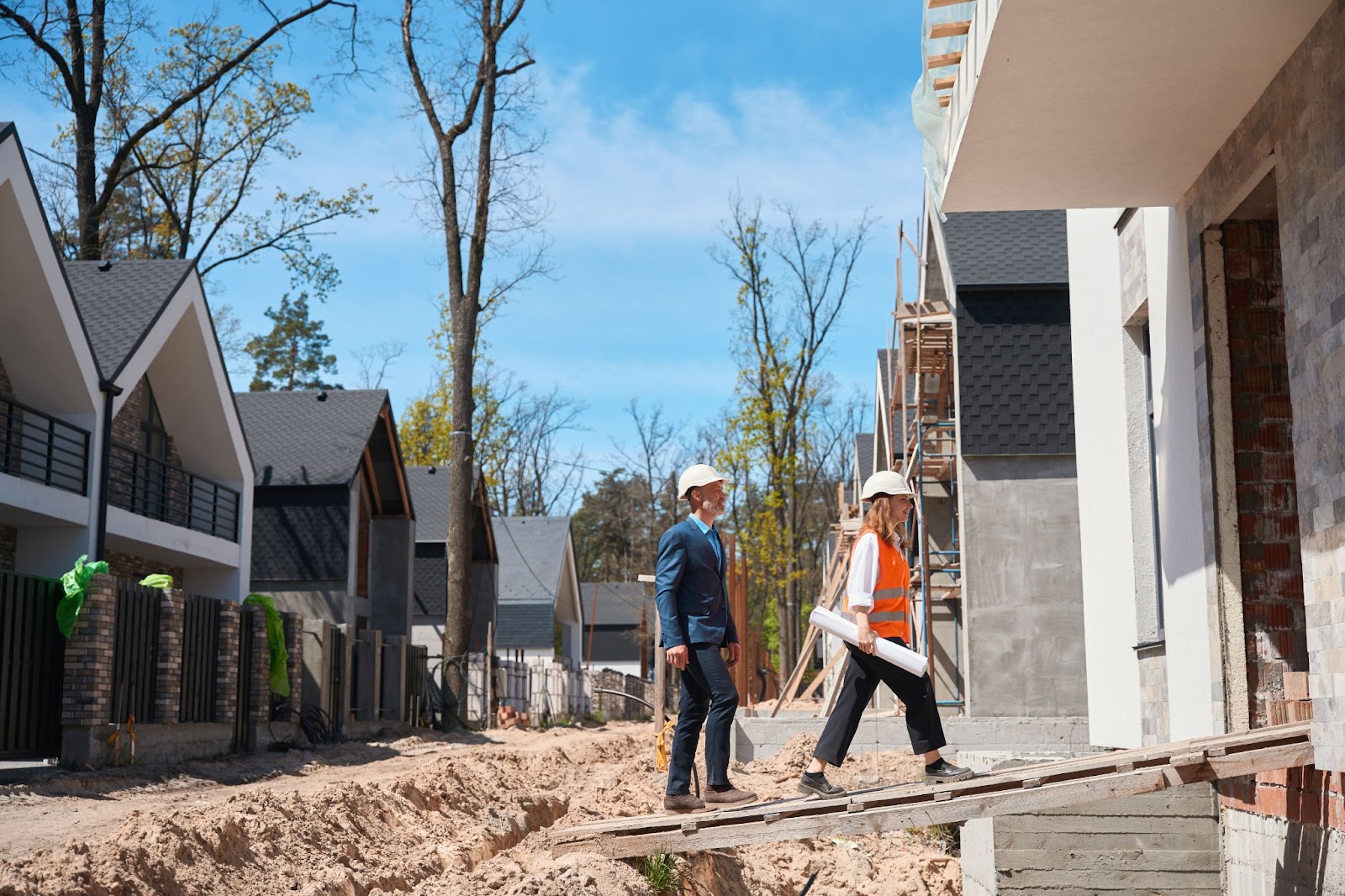 Residential concrete contractors inspect a home construction site to ensure quality, safety, and proper installation.