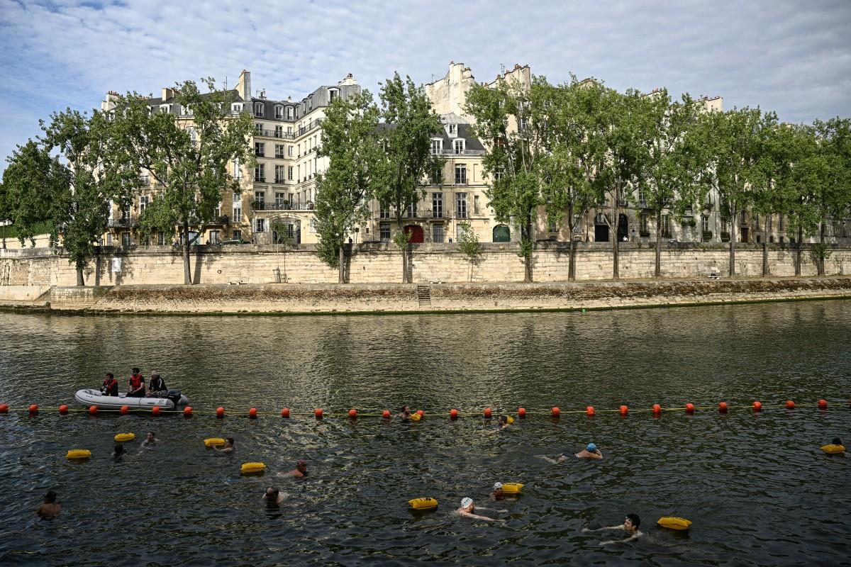 People swim at the Pont Marie.