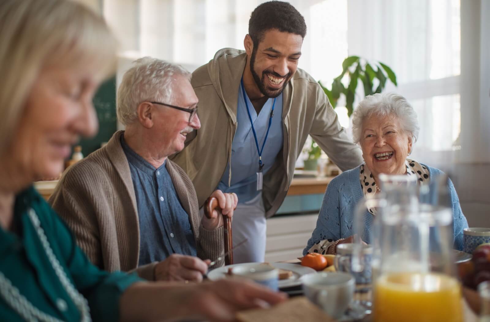 A group of seniors at a memory care community enjoying time together with friends