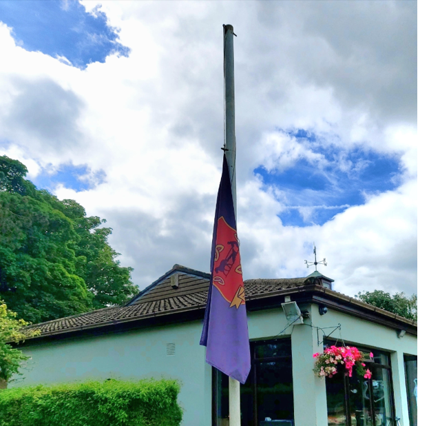 A flag pole with a flag on it

Description automatically generated