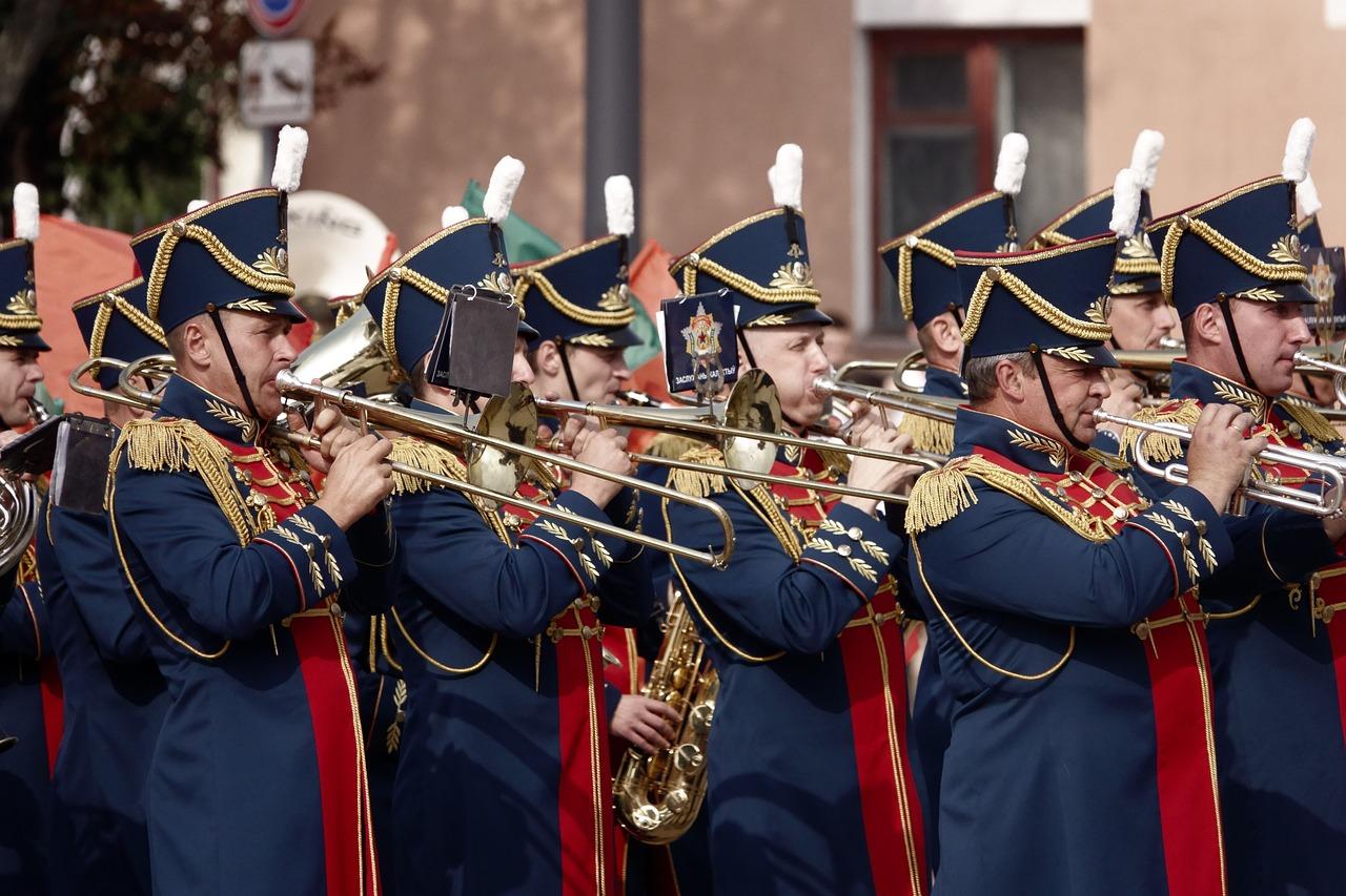 A group of people in uniform playing instruments

Description automatically generated