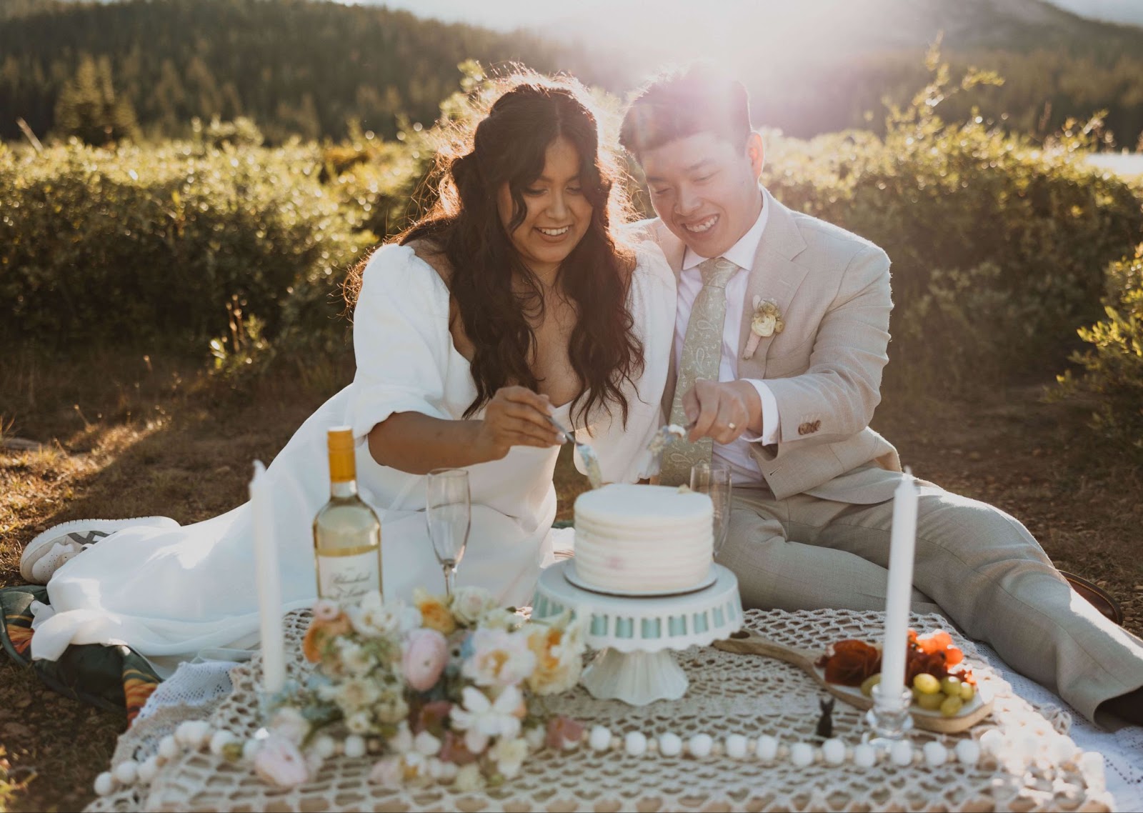 bride and groom cutting cake outside for Brainard Lake elopement