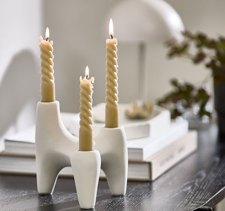 A candles in a holder

Description automatically generated