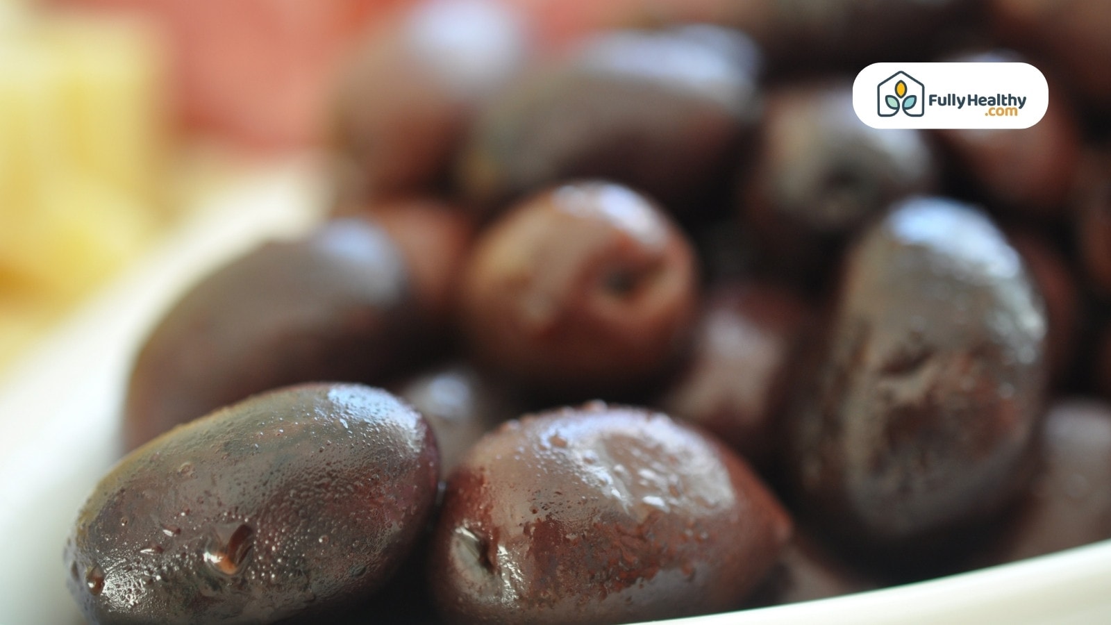 Close-up of fresh black olives with blurred background