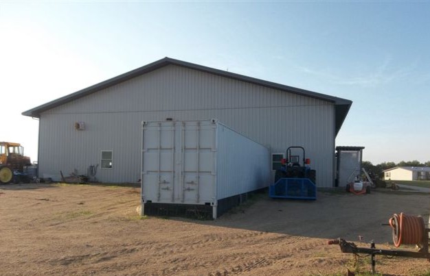 a shipping container being used on a farm for storage