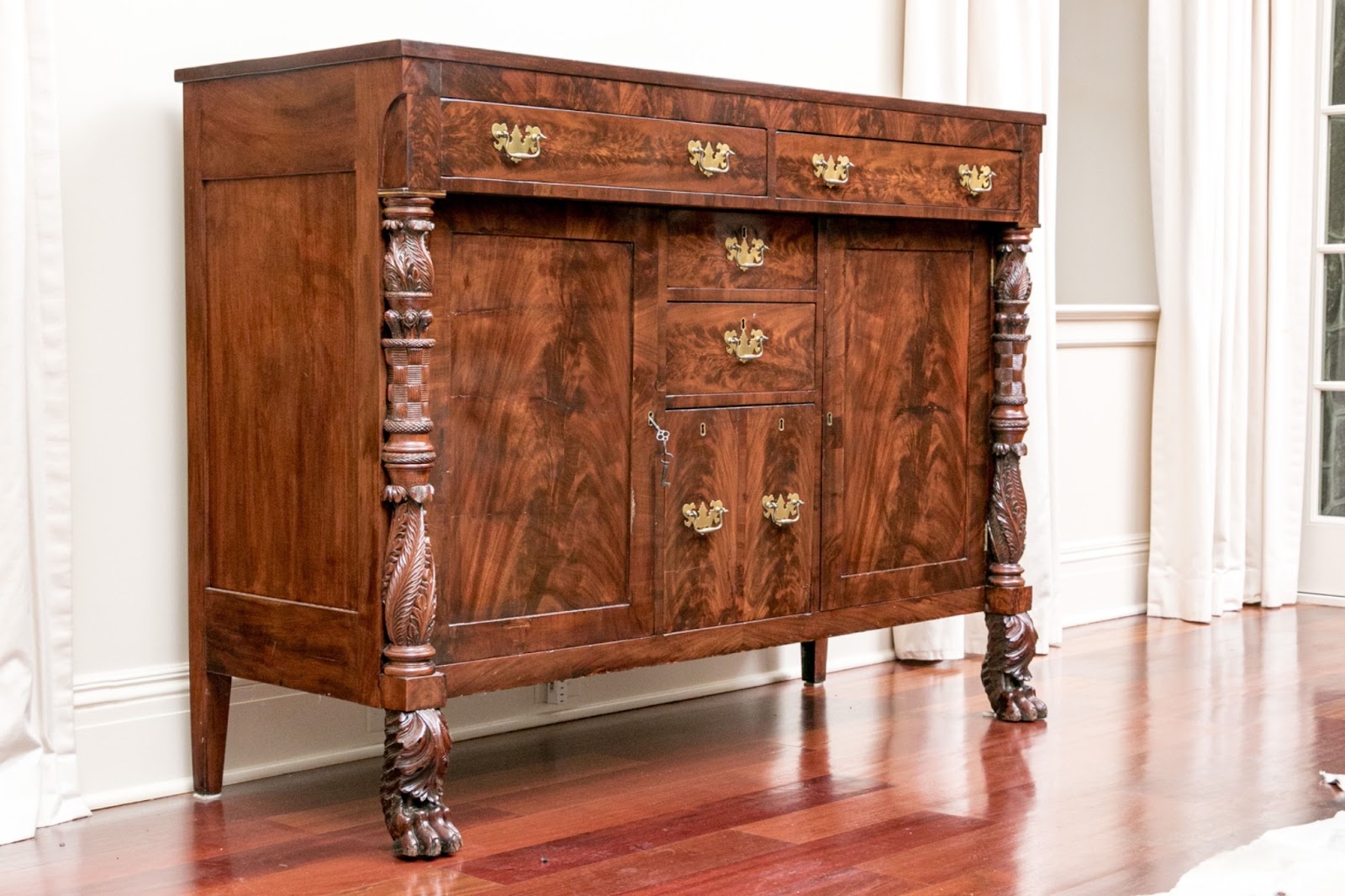 19th century mahogany sigdeboard with intricately carved front legs