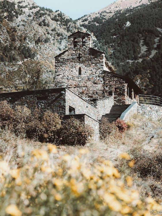 Old stone church on the side of a mountain. 