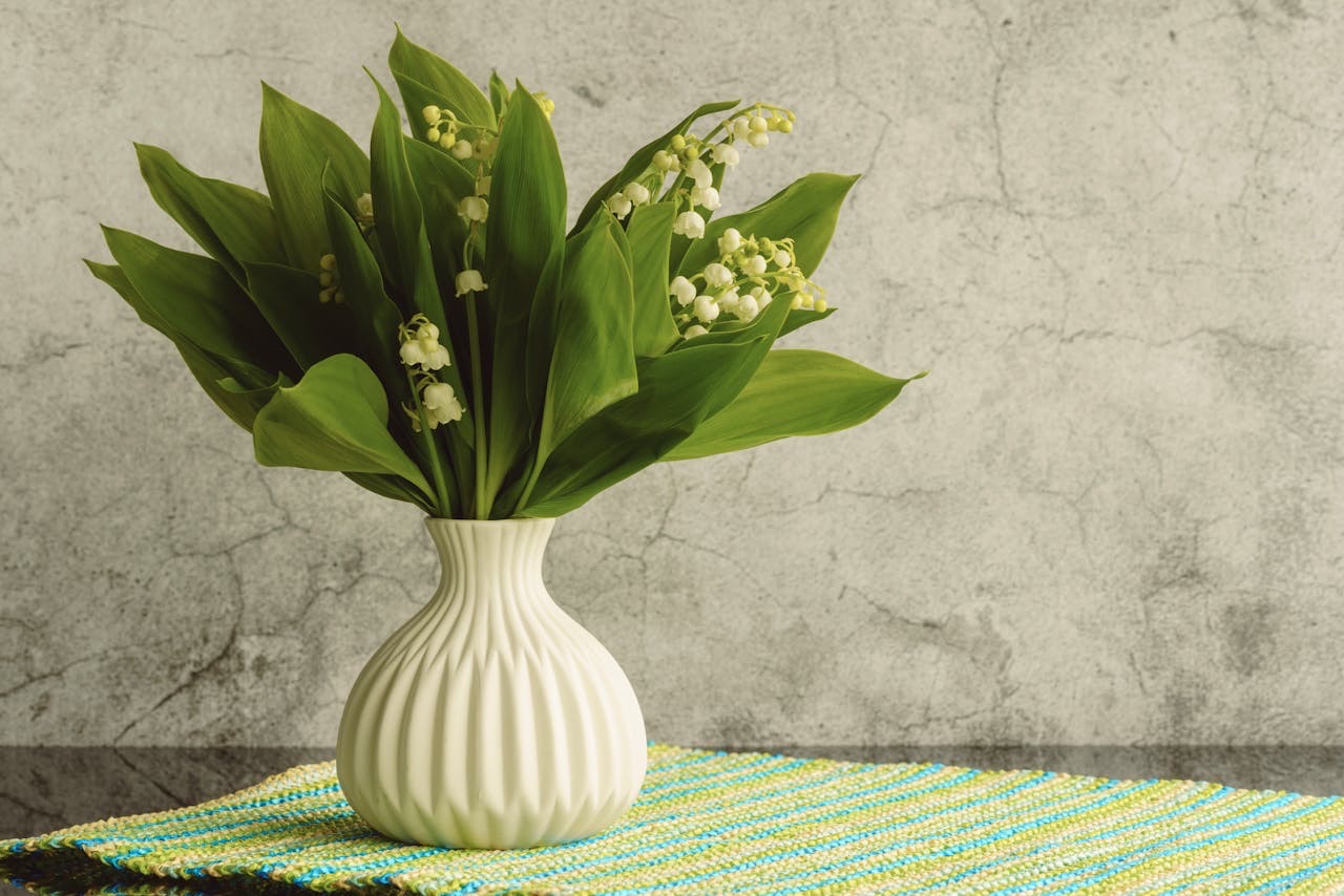 Plant in green vase on colourful table mat // Healthier Baby Today