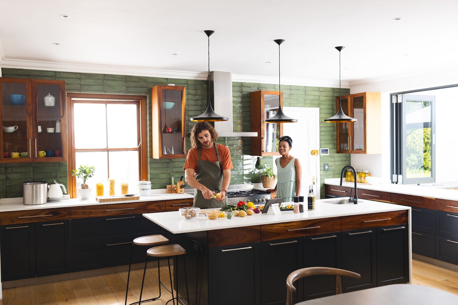 A happy couple preparing a meal in the kitchen. 