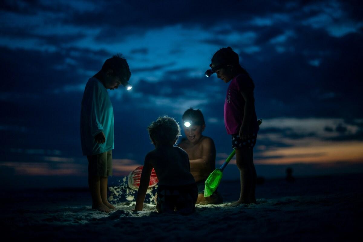 Kids playing scavenger hunt on the beach
