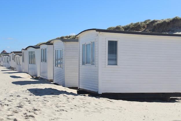 Row of white cabins on the Lokken beach, Denmark