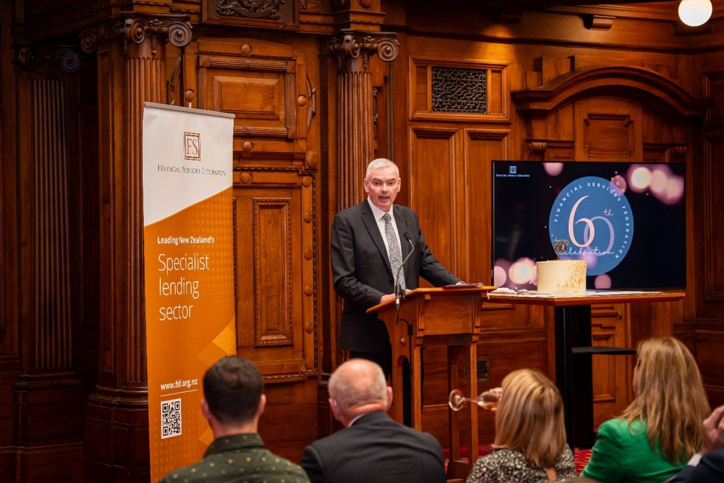 A person standing at a podium with a crowd of people in
the background<p>AI-generated content may be
incorrect.