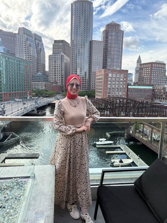 A person standing on a balcony with a city in the background

AI-generated content may be incorrect.