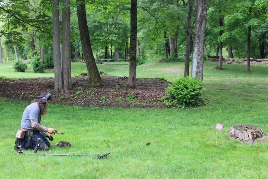 A person playing with a metal detector

Description automatically generated