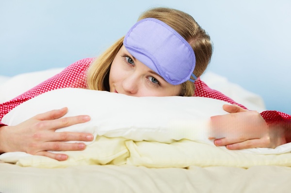 A sloping pillow with a deep indentation in the middle, designed to keep the head and neck elevated and aligned with the spine.