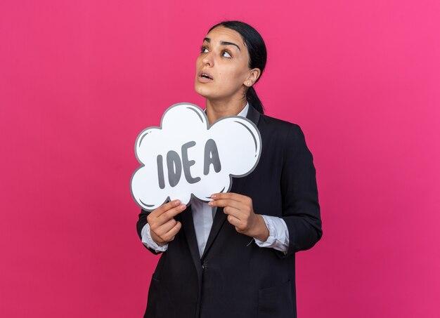 Thinking looking side young beautiful woman wearing black blazer holding idea bubble 