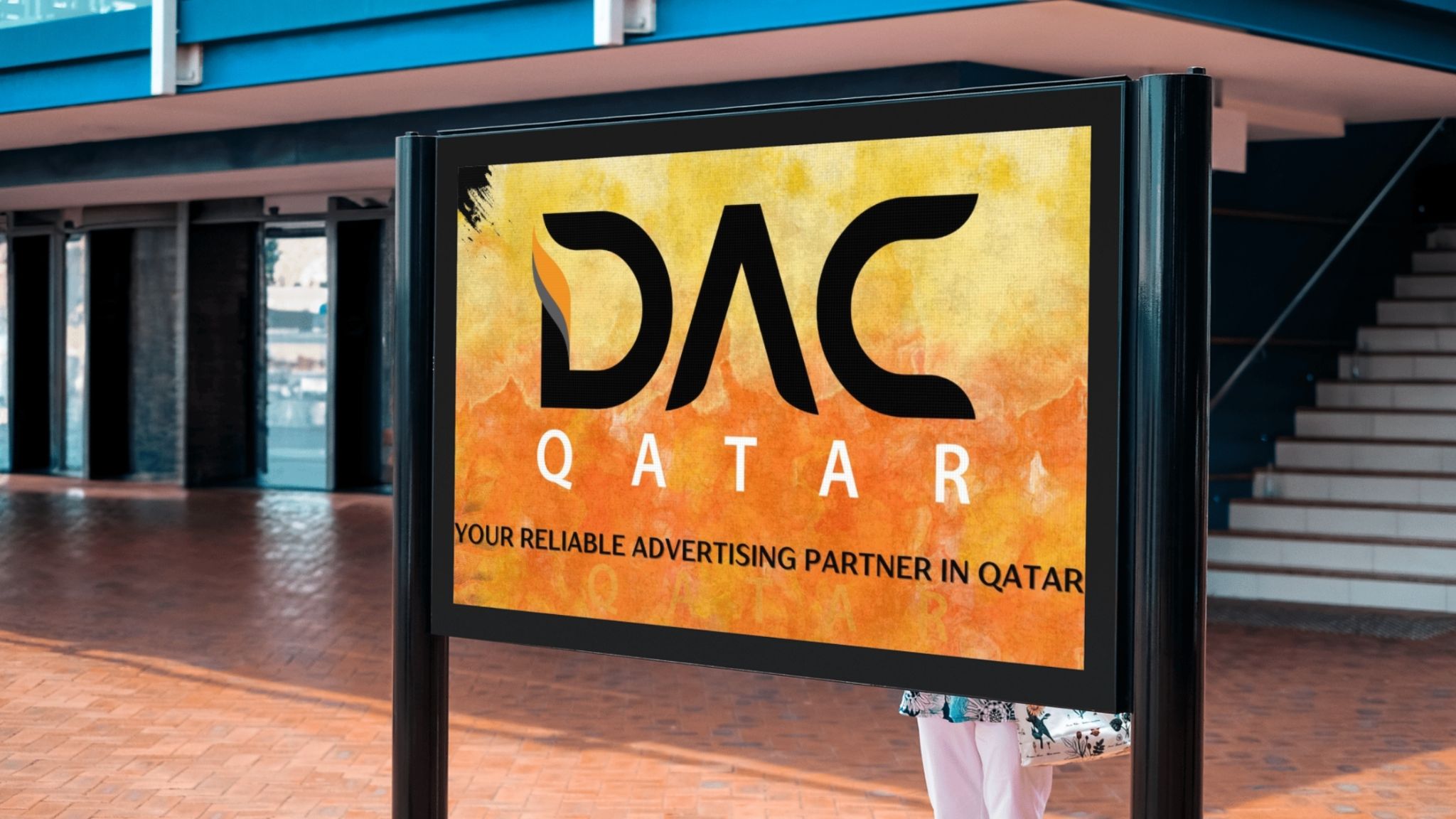 DAC Qatar – Your Trusted Advertising Partner in Qatar. A digital outdoor advertising display featuring the DAC Qatar logo with the tagline "Your Reliable Advertising Partner in Qatar," set in a modern urban environment.
