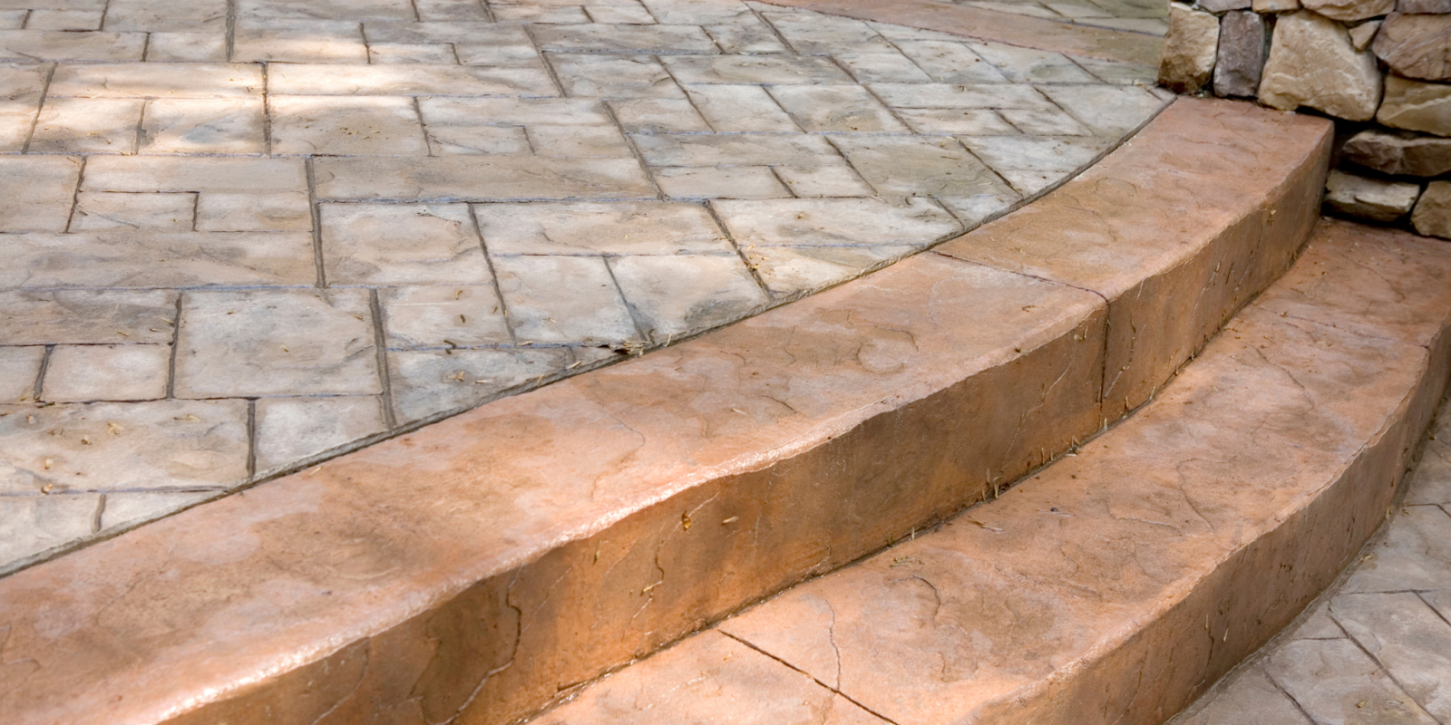 Stamped Concrete vs. Pavers: Which is Best for Your Outdoor Project?