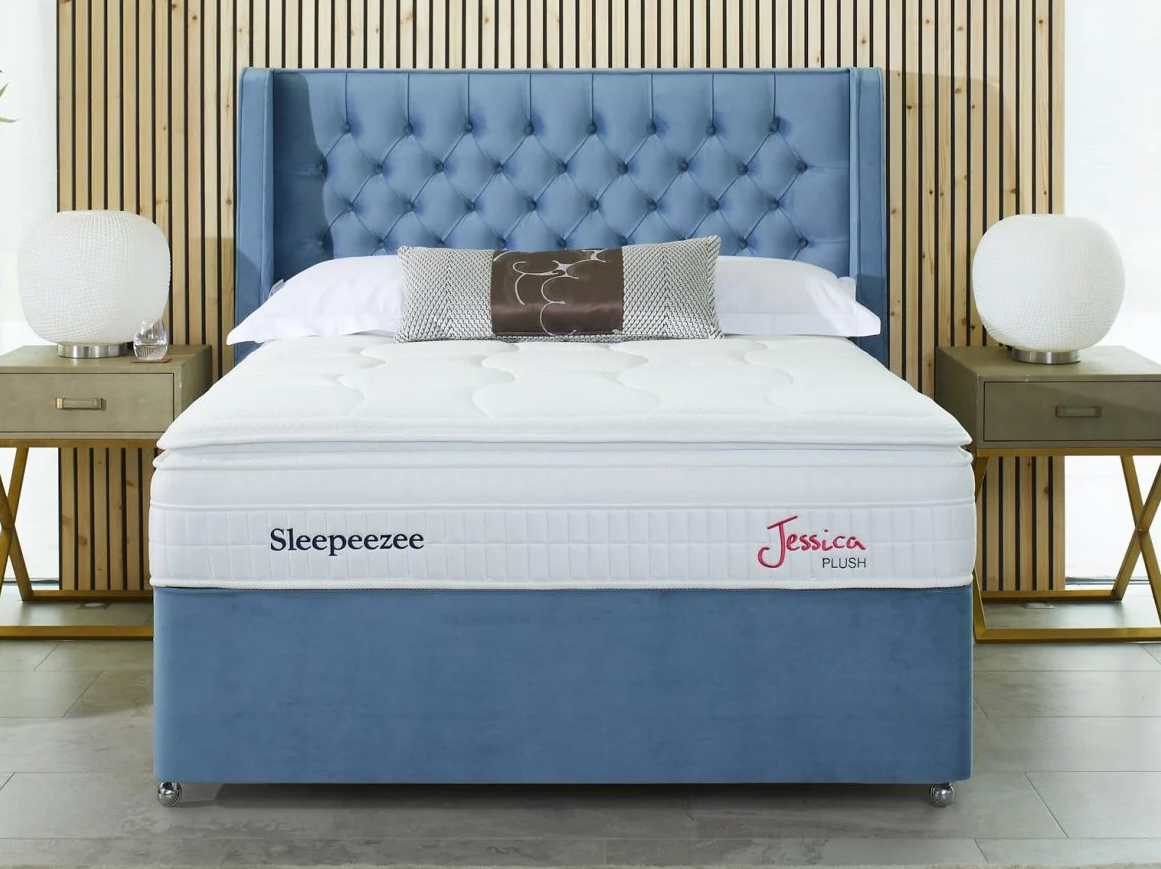 A bed with a blue headboard

AI-generated content may be incorrect.
