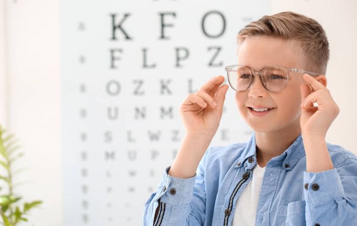 A child at an ophtholmologist's office wearing glasses