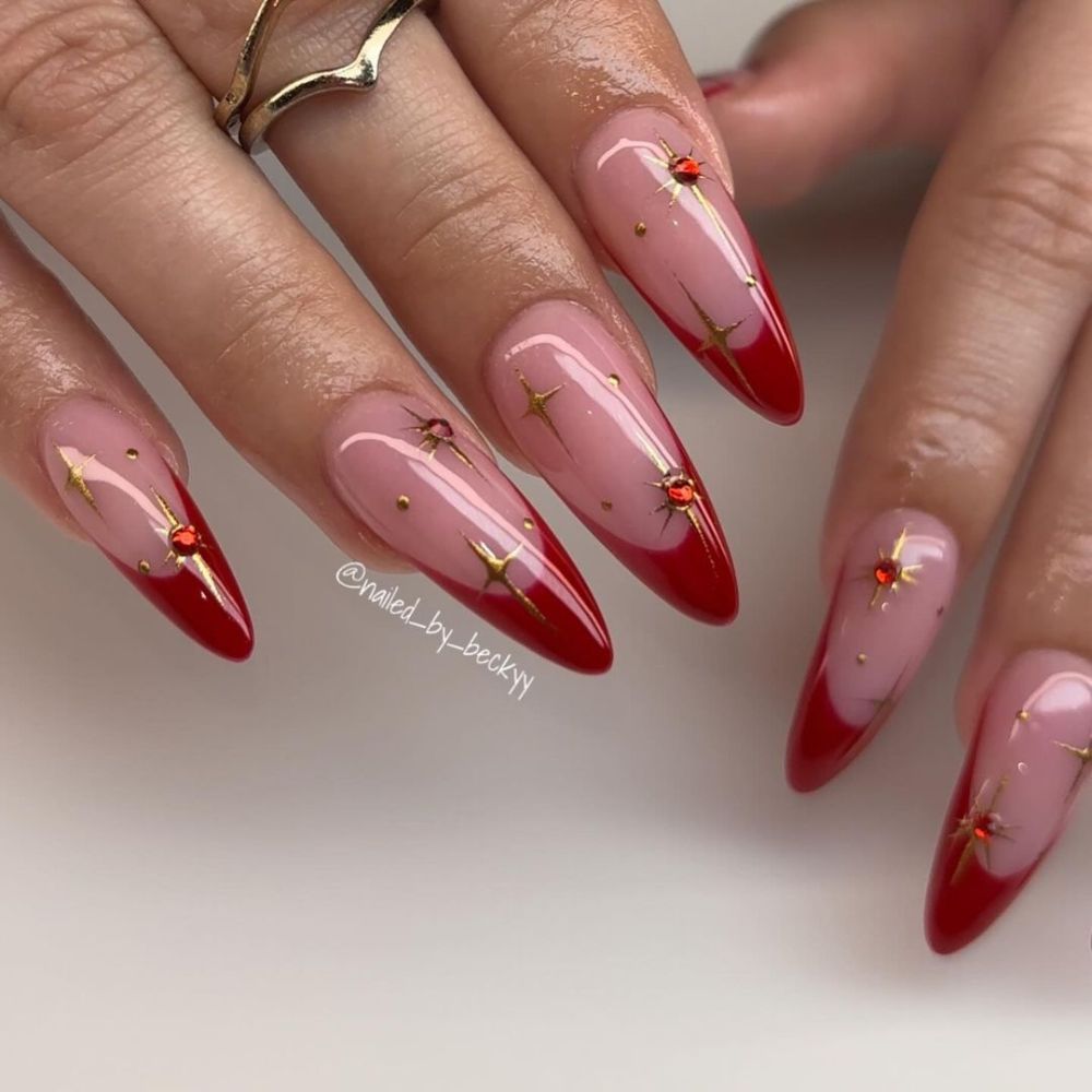 Close up of hands having Christmas red nails with Starry Red Night Nails