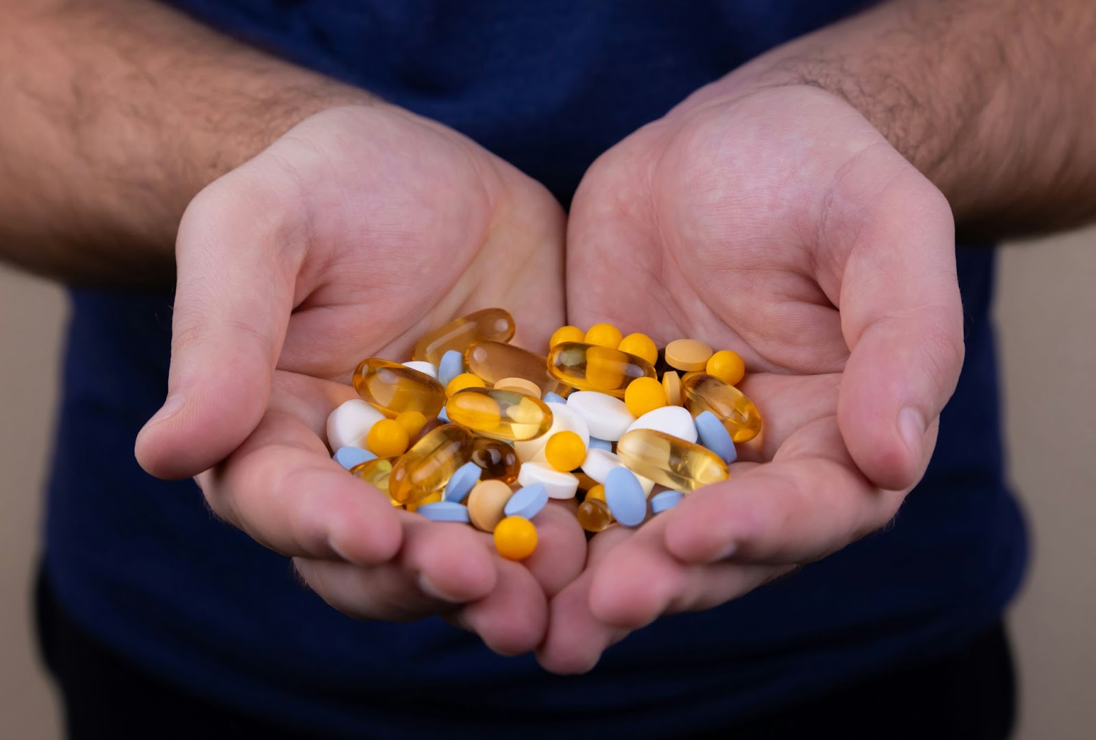 Holding a handful of softgel capsules