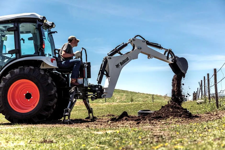 a man using the bobcat backhoe loader