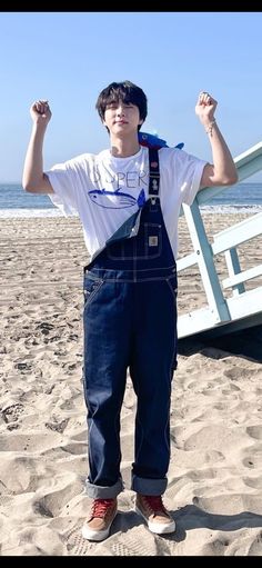 This contains an image of: Jin wearing the  "Super Tuna" shirt at the beach 