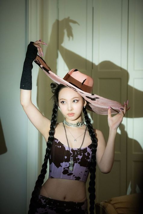 This contain a picture of Nayeon's solo debut with long braids wearing a hat 