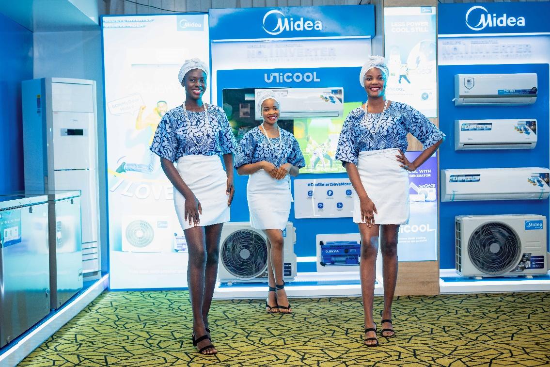 A group of women standing in front of a display

Description automatically generated