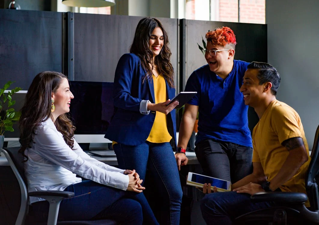 Diverse team sharing ideas and laughter, highlighting the benefits of onboarding for stronger workplace culture