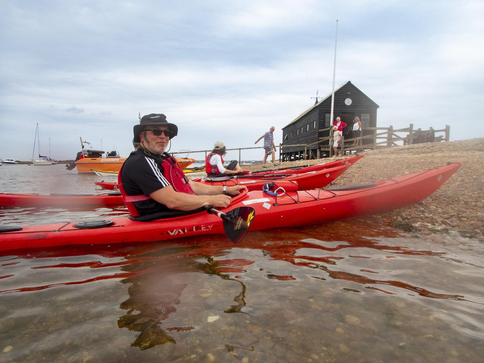 A person in a kayak on the water

Description automatically generated