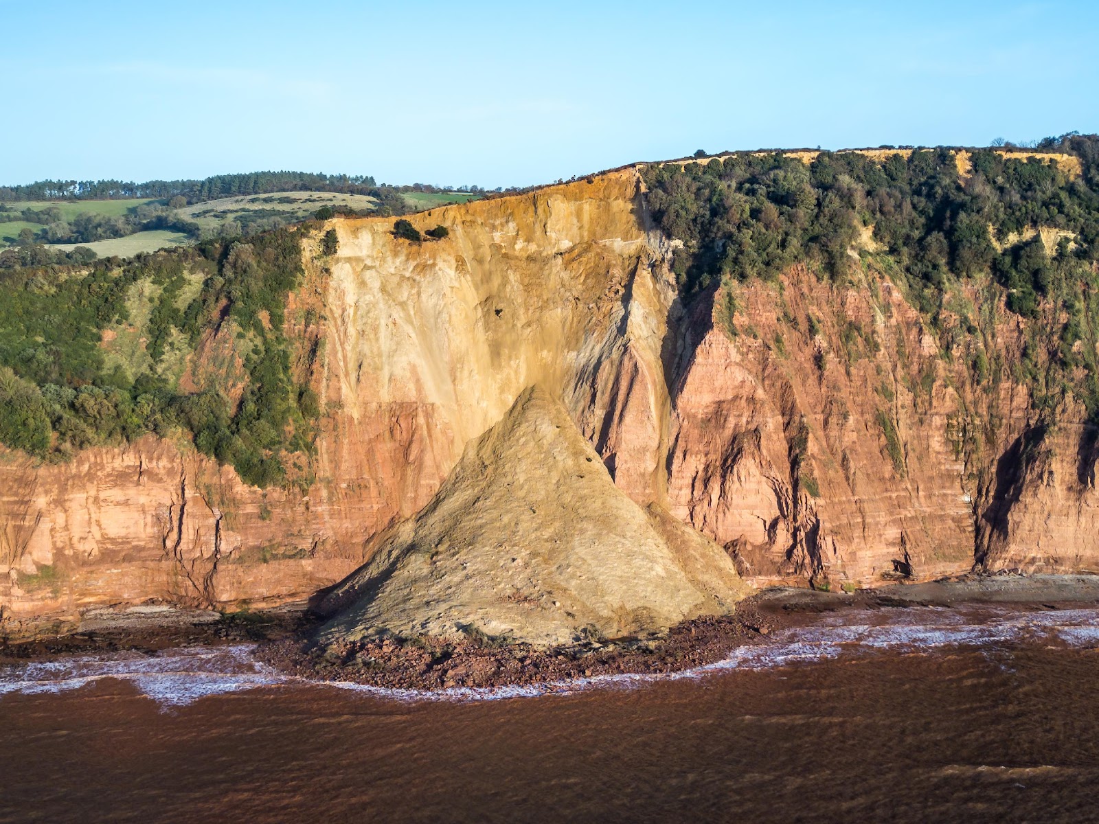 A cliff with trees on it

Description automatically generated