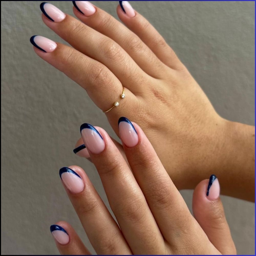 Zoom in view of hand with simple French tip nail having Navy blue French tips