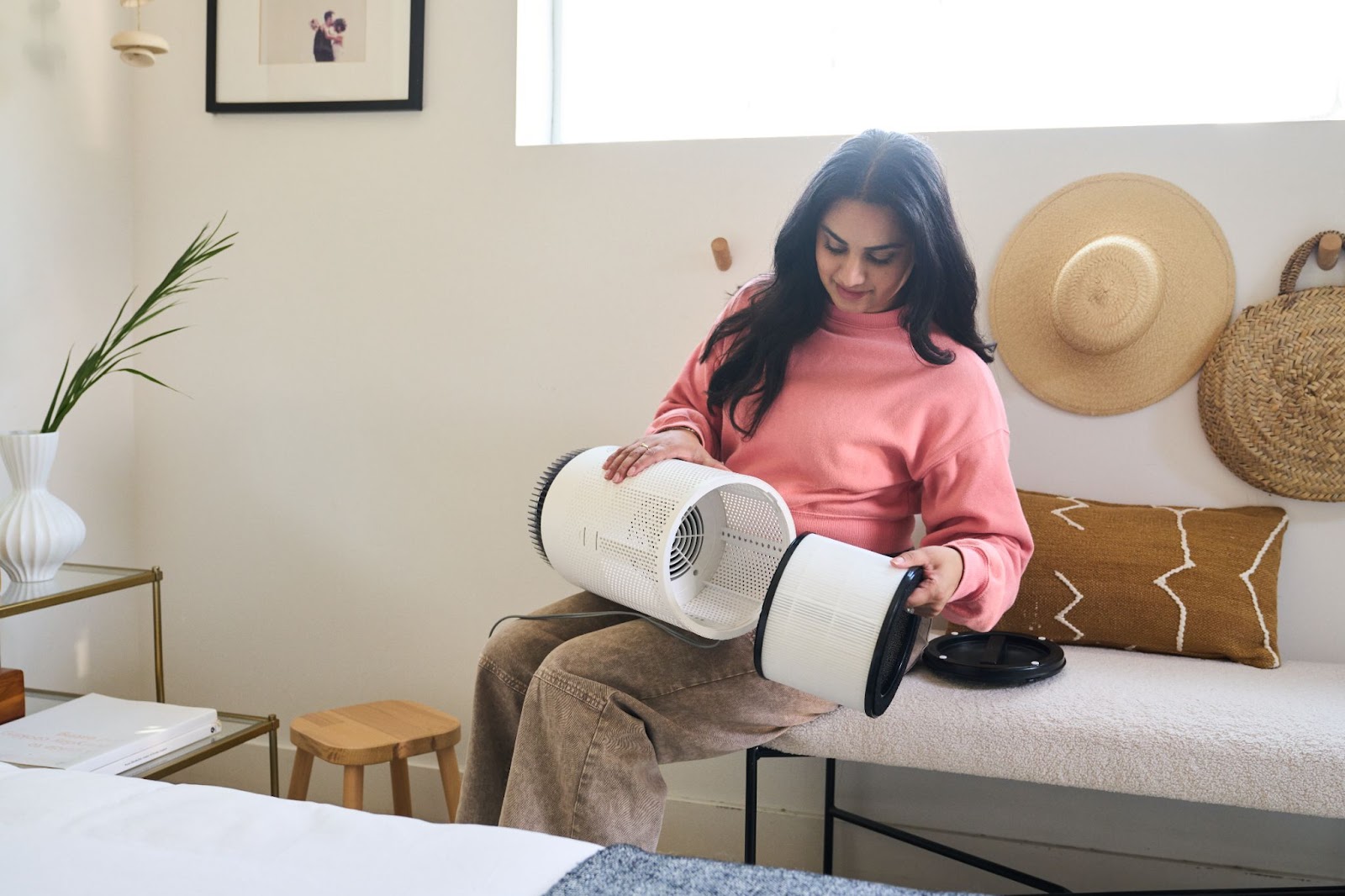 A woman installing the Airmega 50’s filter