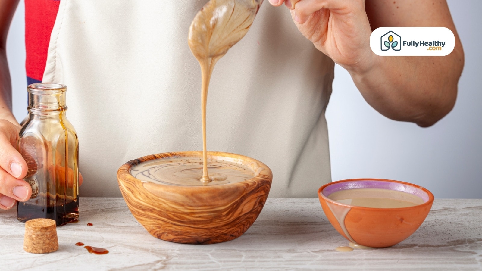 Person preparing dipping sauce mixed with molasses in a bowl