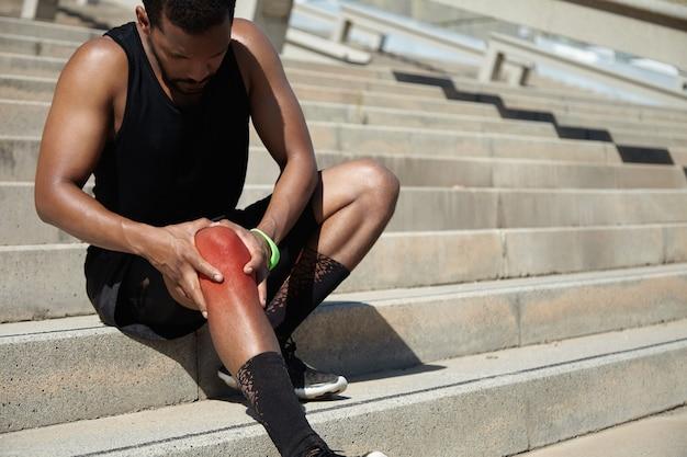 Closeup of young man with knee injury