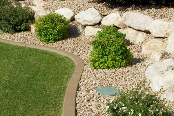 ideas for a small front yard, add small rocks into a landscape design for low maintenance