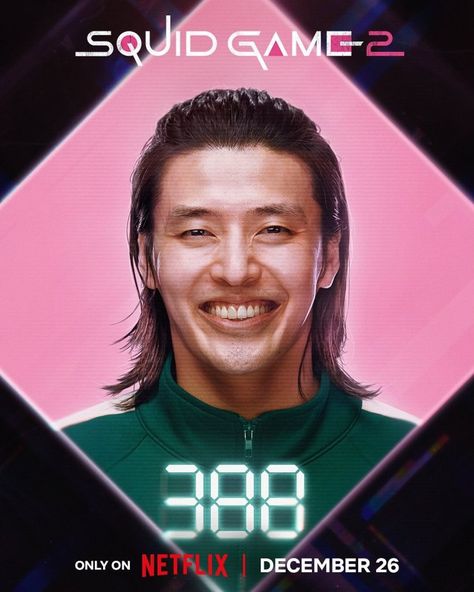 This contains an image of Kang Ha Neul's character, Dae Ho Player 388 with a long hair smiling in front of a pink and black background that says squid game 2