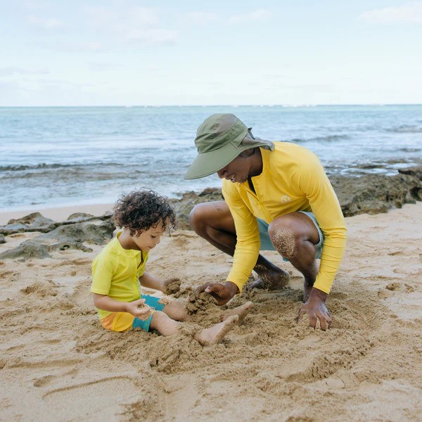 Father with Olive wide brim flap neck hat by SwimZip and his son at the beach—Best hats for sun protection (a guide)