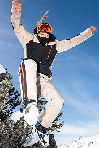 Young man leaping in stylish Bogner ski wear - luxury ski fashion